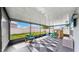 Screened patio with playful zone, geometric rug, seating, and view of fenced yard at 17136 Sunshine Mimosa: St, Wimauma, FL 33598