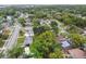 Aerial view of a residential neighborhood with tree-lined streets and various houses at 1807 E Bougainvillea Ave, Tampa, FL 33612