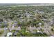 This aerial view shows a neighborhood filled with lush trees and greenery, showcasing the community's serene setting at 1807 E Bougainvillea Ave, Tampa, FL 33612
