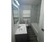 Updated bathroom with new vanity, mirror, lighting, tiling, bath and toilet at 1807 E Bougainvillea Ave, Tampa, FL 33612