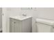 Bathroom featuring a gray vanity with a white sink top, alongside a toilet, creating a functional space at 1807 E Bougainvillea Ave, Tampa, FL 33612