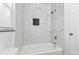 Bathroom featuring a shower/tub with marble-like tile and modern finishes at 1807 E Bougainvillea Ave, Tampa, FL 33612
