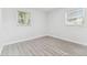 Bedroom with durable flooring, two windows, and white trim at 1807 E Bougainvillea Ave, Tampa, FL 33612
