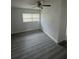An ample bedroom features new flooring and a ceiling fan at 1807 E Bougainvillea Ave, Tampa, FL 33612