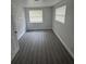 This bedroom has a brick accent wall and new flooring at 1807 E Bougainvillea Ave, Tampa, FL 33612