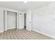 Comfortable bedroom featuring a painted brick wall accent, wood-look flooring, and closet at 1807 E Bougainvillea Ave, Tampa, FL 33612