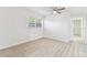 Bright bedroom featuring wood-look flooring, fresh paint, and ample natural light at 1807 E Bougainvillea Ave, Tampa, FL 33612