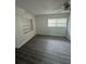 A bright bedroom offers fresh paint, new flooring, built in shelves and a ceiling fan at 1807 E Bougainvillea Ave, Tampa, FL 33612