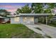 Charming single-story home featuring a covered carport and a well-maintained front yard at 1807 E Bougainvillea Ave, Tampa, FL 33612
