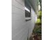 Long, gray wood-sided house with a window and minimal landscaping at 1807 E Bougainvillea Ave, Tampa, FL 33612
