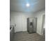 A modern, stainless steel refrigerator in a bright kitchen with sleek, light woodgrain floors at 1807 E Bougainvillea Ave, Tampa, FL 33612