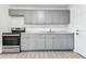Efficient kitchen with stainless steel appliances, grey cabinets and modern countertops at 1807 E Bougainvillea Ave, Tampa, FL 33612