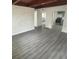 Bright living room showcasing hardwood floors, a wooden beam ceiling, and a decorative painted brick wall at 1807 E Bougainvillea Ave, Tampa, FL 33612