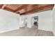 Bright living room with wood beam ceiling, freshly painted walls, and modern wood-look floors at 1807 E Bougainvillea Ave, Tampa, FL 33612