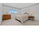 Bedroom featuring neutral walls, carpet, a queen bed, and bedside tables with lamps at 18219 Bittern Ave, Lutz, FL 33558