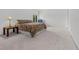 Spacious bedroom with neutral carpet, patterned queen size bed, and a sitting area at 18219 Bittern Ave, Lutz, FL 33558