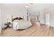 Bright Primary bedroom featuring vinyl wood flooring, neutral walls, and natural light at 18219 Bittern Ave, Lutz, FL 33558