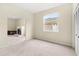 Neutral bedroom showcasing a fireplace and a view into another room at 18219 Bittern Ave, Lutz, FL 33558