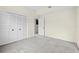 A neutral-toned bedroom features carpeted flooring and double closet doors at 18219 Bittern Ave, Lutz, FL 33558