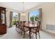Elegant dining room with a large table, chandelier, and natural light from the windows at 18219 Bittern Ave, Lutz, FL 33558