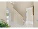 Open foyer with tile floors, staircase, and view of the screened-in pool through the doorway at 18219 Bittern Ave, Lutz, FL 33558