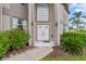 Close-up of the front entrance, showcasing the double doors and tasteful landscaping at 18219 Bittern Ave, Lutz, FL 33558