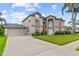 Well-maintained two-story home with a long driveway, manicured lawn, and mature landscaping at 18219 Bittern Ave, Lutz, FL 33558