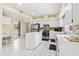 Bright kitchen features white cabinets, stainless steel appliances, and center island at 18219 Bittern Ave, Lutz, FL 33558
