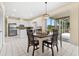 Bright kitchen features white cabinets, stainless steel appliances, and adjacent dining area at 18219 Bittern Ave, Lutz, FL 33558