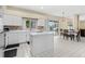 Bright kitchen boasts white cabinets, an island, and a view of the inviting outdoor pool area at 18219 Bittern Ave, Lutz, FL 33558