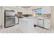 Bright kitchen features white cabinets, stainless steel appliances, and center island at 18219 Bittern Ave, Lutz, FL 33558