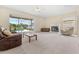 Spacious living room with a fireplace and sliding glass doors leading to a screened-in pool area at 18219 Bittern Ave, Lutz, FL 33558