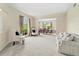 Spacious living room with neutral tones, plush carpeting, and large windows offering natural light at 18219 Bittern Ave, Lutz, FL 33558