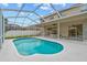 Beautiful view of screened-in pool with patio dining and backyard at 18219 Bittern Ave, Lutz, FL 33558