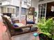 Relaxing back porch with wicker seating, a fire pit, and sliding glass doors to the house at 2015 Vista Del Sol # 108, Lutz, FL 33558