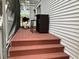 View of a back porch with an outdoor bar, seating, and grill, with access from the stairs at 2015 Vista Del Sol # 108, Lutz, FL 33558