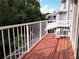 Balcony with wood flooring, white railing, and treetop views providing a serene outdoor space at 2015 Vista Del Sol # 108, Lutz, FL 33558
