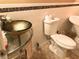 Bathroom with a modern golden vessel sink and decorative tile accents at 2015 Vista Del Sol # 108, Lutz, FL 33558