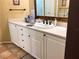 Bathroom vanity with white cabinets and sink at 2015 Vista Del Sol # 108, Lutz, FL 33558