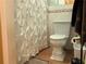 Bathroom with a white toilet and decorative shower curtain at 2015 Vista Del Sol # 108, Lutz, FL 33558