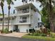 Two-story condo with dual balconies, a garage, lush landscaping and brick paver driveway at 2015 Vista Del Sol # 108, Lutz, FL 33558