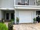 Street view of unit, showing garage, front door and landscaping at 2015 Vista Del Sol # 108, Lutz, FL 33558