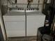 Functional laundry room with a modern white washer and dryer set at 2015 Vista Del Sol # 108, Lutz, FL 33558