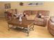 Comfortable living room featuring a plush sofa, coffee table and light-colored hardwood floors at 2015 Vista Del Sol # 108, Lutz, FL 33558