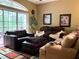 Living room area with a plush sofa and a view of the backyard at 2015 Vista Del Sol # 108, Lutz, FL 33558