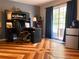 Home office with a large desk, wood flooring, and blue curtains at 2015 Vista Del Sol # 108, Lutz, FL 33558