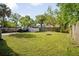Fenced backyard with mature trees and space for outdoor activities, providing privacy at 216 W South Ave, Tampa, FL 33603