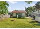Backyard view featuring a fire pit with lawn and vehicle parking at 216 W South Ave, Tampa, FL 33603