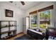 Bedroom with hardwood floors, a ceiling fan, a storage shelf, and a large window at 216 W South Ave, Tampa, FL 33603