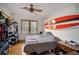 Comfortable bedroom with wood floors, natural light, and surf-inspired decor, offering a relaxing and stylish retreat at 216 W South Ave, Tampa, FL 33603